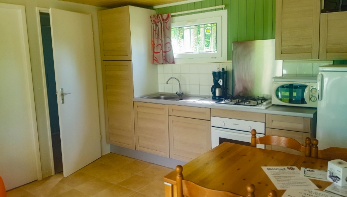 The kitchen of the cottage for rent at Lake Cormoranche*** campsite in Ain