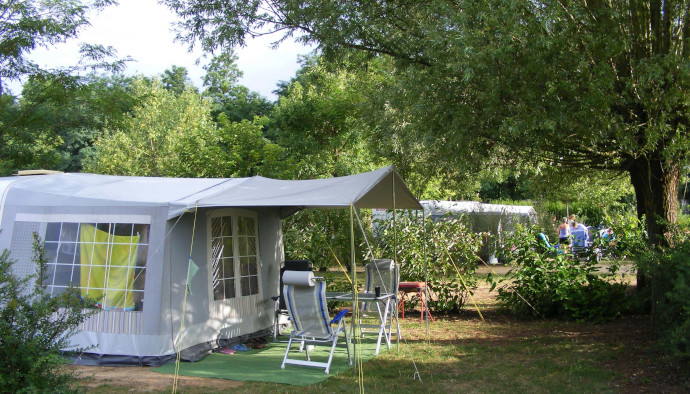 Shaded pitch for a tent at Lake Cormoranche **** campsite in Ain